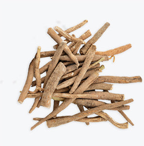 A pile of dried, brown herbal roots on a white background.