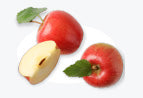 Red apples with leaves, one sliced, on a light background.
