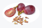 Whole and halved red grapes with seeds on a white background.
