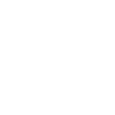 A person sitting cross-legged, smiling while using a laptop.